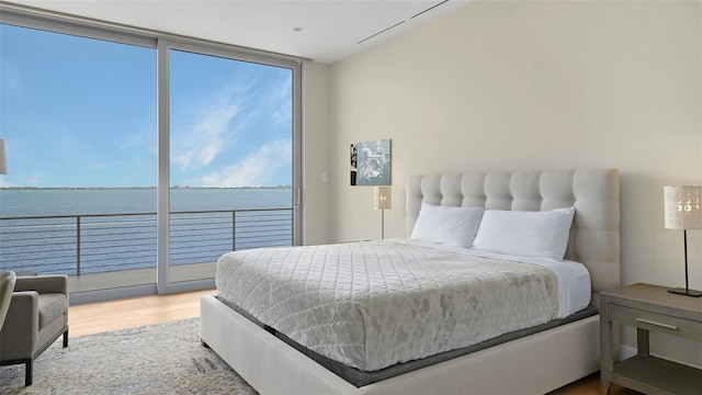 4123 Bay Shore Rd, Sarasota, FL 34234 - bedroom with wood finished floors, floor to ceiling windows, and a water view