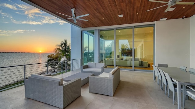4123 Bay Shore Rd, Sarasota, FL 34234 - view of patio featuring ceiling fan, an outdoor living space, and a water view