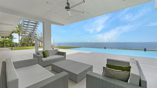 4123 Bay Shore Rd, Sarasota, FL 34234 - view of patio featuring stairs, a ceiling fan, an outdoor living space, and a water view