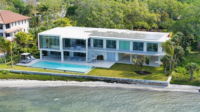 4123 Bay Shore Rd, Sarasota, FL 34234 - back of property featuring stairway, a patio area, a lawn, an outdoor pool, and a water view