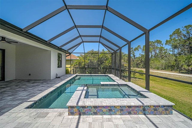 outdoor pool with a patio, an in ground hot tub, and a lawn