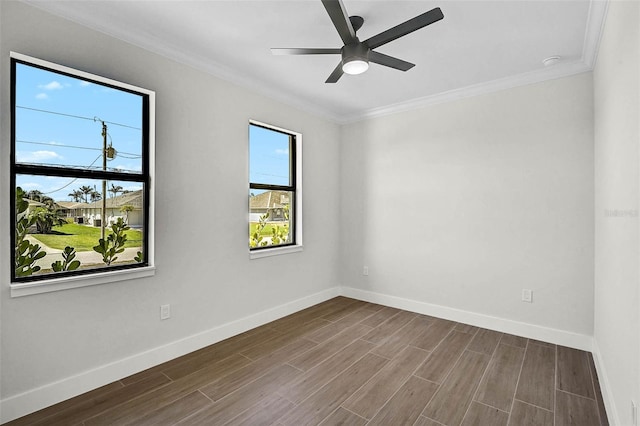 empty room featuring wood finished floors, a ceiling fan, crown molding, and baseboards