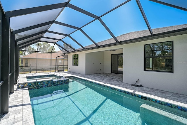 view of swimming pool featuring a patio, ceiling fan, a pool with connected hot tub, and a lanai