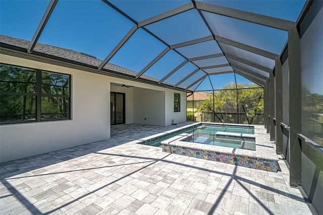 view of pool with a patio, glass enclosure, and a ceiling fan