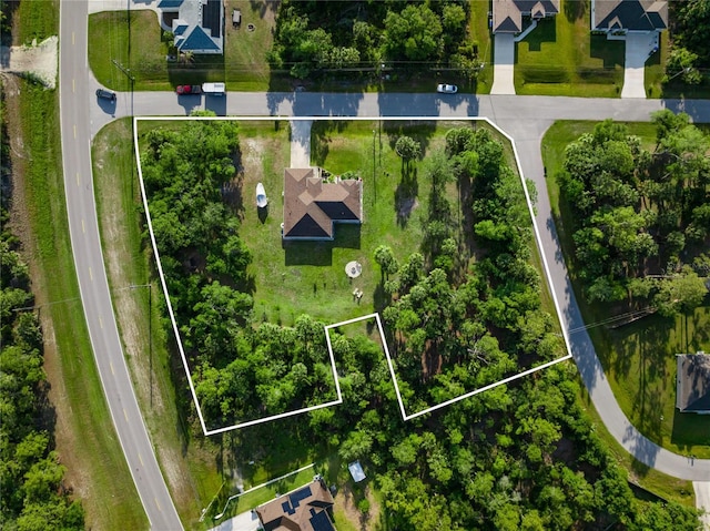 birds eye view of property with a residential view