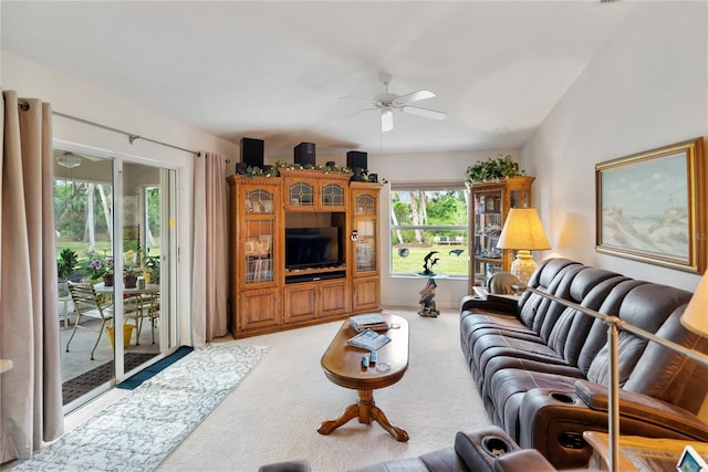 living area with light colored carpet and a ceiling fan