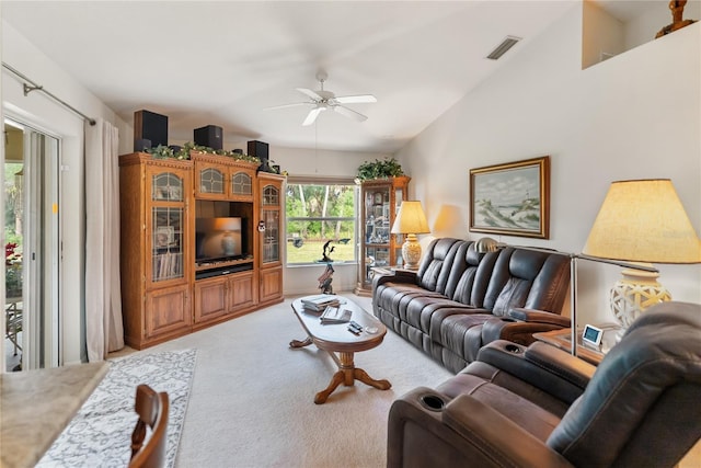 living area featuring lofted ceiling, carpet, visible vents, and a ceiling fan