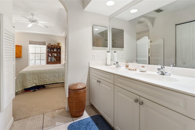 bathroom featuring ceiling fan, connected bathroom, double vanity, and a sink