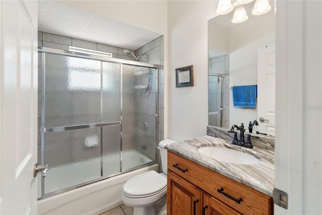 bathroom with toilet, enclosed tub / shower combo, and vanity