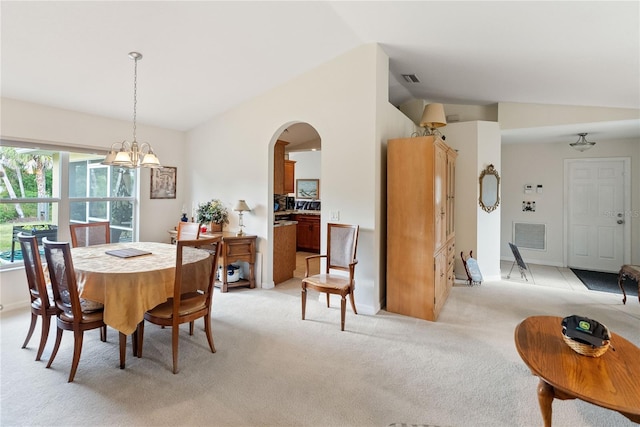 dining space with arched walkways, light carpet, visible vents, a notable chandelier, and lofted ceiling