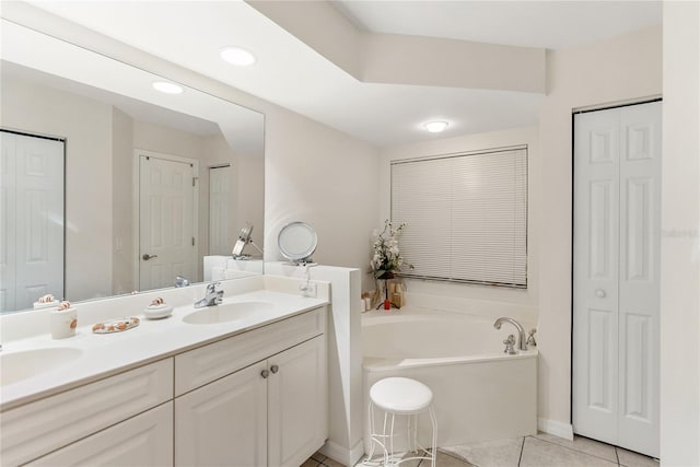 bathroom with tile patterned floors, a sink, and a closet