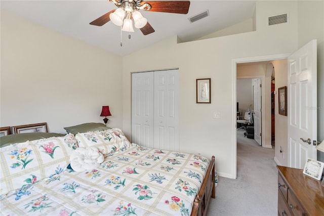 bedroom featuring a closet, visible vents, vaulted ceiling, and carpet floors