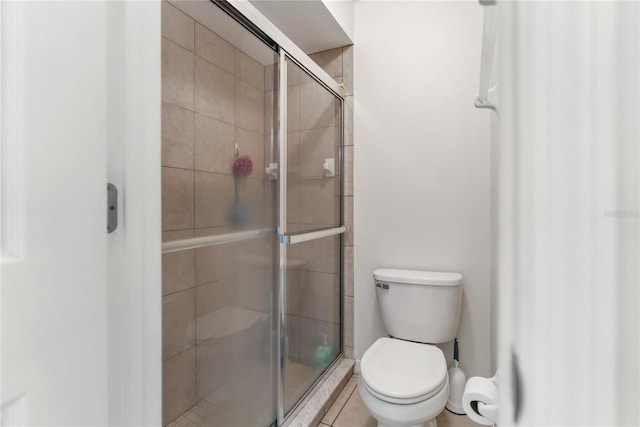 full bathroom with a stall shower and toilet
