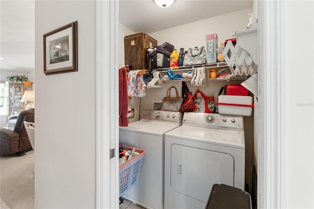 clothes washing area featuring washer and clothes dryer and laundry area