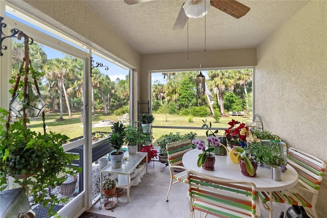 sunroom / solarium featuring a ceiling fan