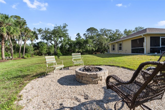 view of yard with an outdoor fire pit