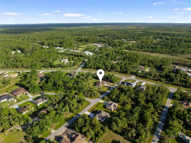 birds eye view of property featuring a wooded view