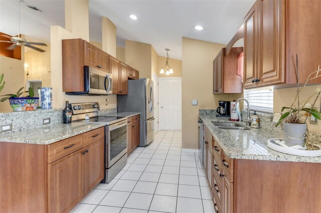 3640 Gloxinia Dr, North Fort Myers, FL 33917 - kitchen featuring light tile patterned floors, a sink, stainless steel appliances, light stone countertops, and ceiling fan with notable chandelier