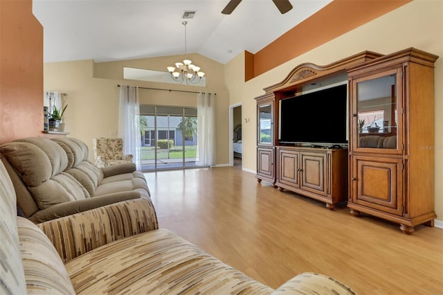 3640 Gloxinia Dr, North Fort Myers, FL 33917 - living room with light wood-type flooring, ceiling fan with notable chandelier, baseboards, visible vents, and high vaulted ceiling