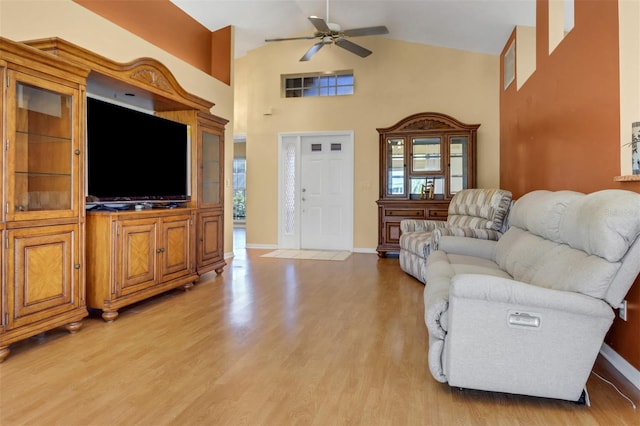 3640 Gloxinia Dr, North Fort Myers, FL 33917 - living room with light wood-type flooring, a ceiling fan, high vaulted ceiling, and baseboards