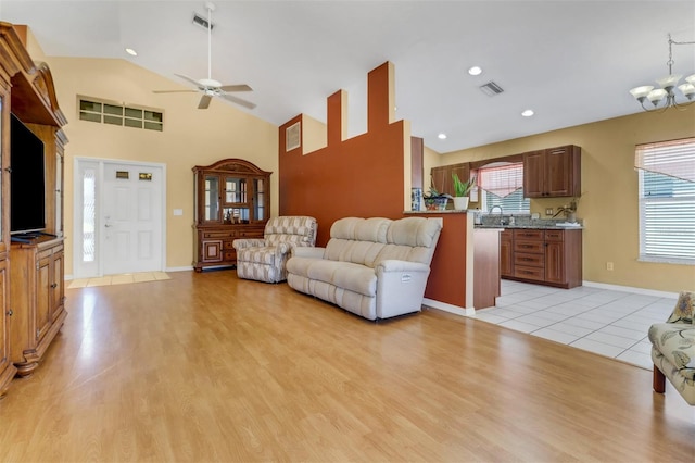 3640 Gloxinia Dr, North Fort Myers, FL 33917 - living area with visible vents, a ceiling fan, light wood finished floors, and high vaulted ceiling
