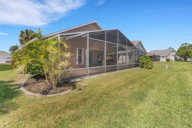 3640 Gloxinia Dr, North Fort Myers, FL 33917 - back of house with a yard and glass enclosure
