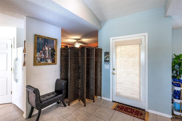 12026 Warwick Cir, Parrish, FL 34219 - entrance foyer featuring a textured ceiling, ceiling fan, and light tile patterned floors