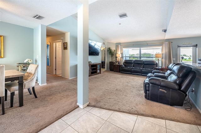 12026 Warwick Cir, Parrish, FL 34219 - living room with light carpet, a textured ceiling, vaulted ceiling, and light tile patterned flooring