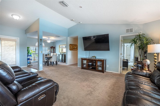 12026 Warwick Cir, Parrish, FL 34219 - carpeted living room featuring a ceiling fan, vaulted ceiling, and a textured ceiling