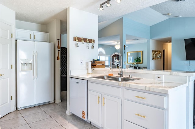 12026 Warwick Cir, Parrish, FL 34219 - kitchen with white appliances, a ceiling fan, a textured ceiling, light tile patterned floors, and white cabinets