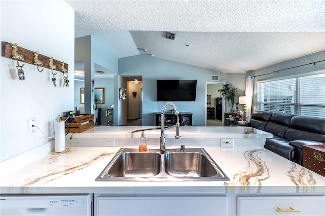 12026 Warwick Cir, Parrish, FL 34219 - kitchen with open floor plan, a textured ceiling, dishwasher, vaulted ceiling, and light countertops