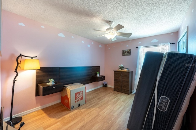 12026 Warwick Cir, Parrish, FL 34219 - bedroom featuring wood finished floors, a textured ceiling, and ceiling fan