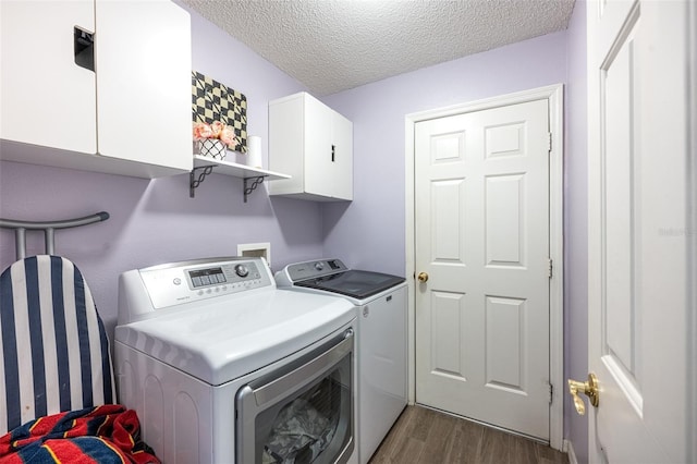 12026 Warwick Cir, Parrish, FL 34219 - washroom with washer and dryer, cabinet space, dark wood-style flooring, and a textured ceiling