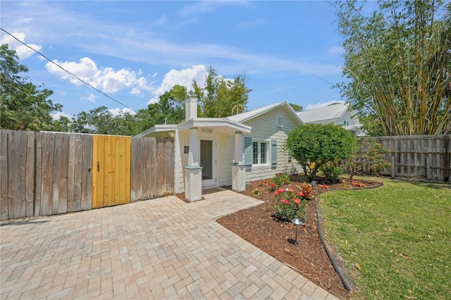 2537 Ashton Rd, Sarasota, FL 34231 - view of front of home with a chimney, fence, a gate, and a front yard