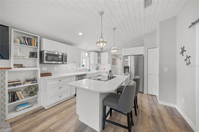 2537 Ashton Rd, Sarasota, FL 34231 - kitchen with white cabinets, stainless steel appliances, open shelves, and a kitchen island