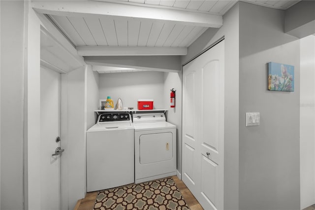 2537 Ashton Rd, Sarasota, FL 34231 - clothes washing area featuring washer and dryer, wooden ceiling, laundry area, and wood finished floors
