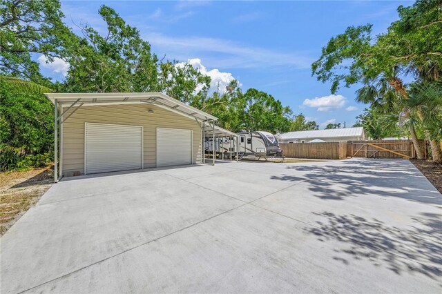 2537 Ashton Rd, Sarasota, FL 34231 - view of property exterior with fence and an outbuilding
