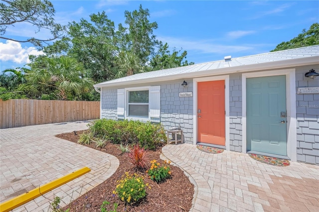 2537 Ashton Rd, Sarasota, FL 34231 - entrance to property featuring metal roof and fence