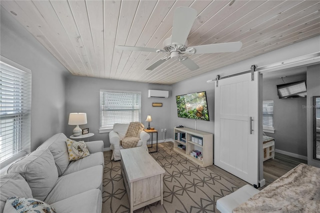 2537 Ashton Rd, Sarasota, FL 34231 - living area with wood ceiling, a barn door, an AC wall unit, wood finished floors, and a ceiling fan