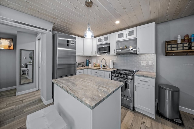 2537 Ashton Rd, Sarasota, FL 34231 - kitchen featuring baseboards, wooden ceiling, stainless steel appliances, and light wood-style flooring