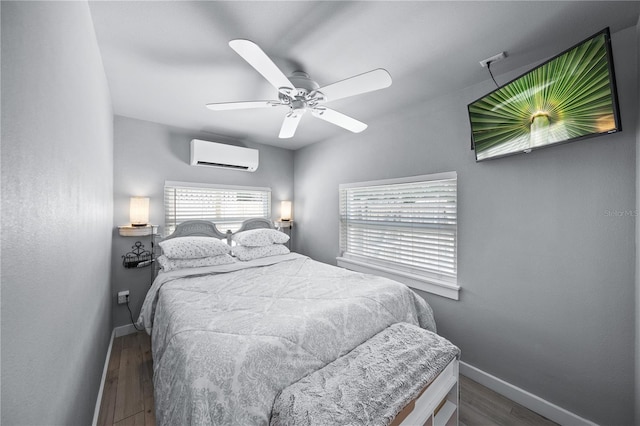2537 Ashton Rd, Sarasota, FL 34231 - bedroom featuring a ceiling fan, a wall unit AC, wood finished floors, and baseboards