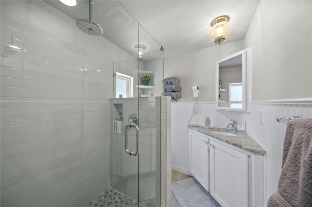 2537 Ashton Rd, Sarasota, FL 34231 - bathroom featuring visible vents, wainscoting, and a stall shower