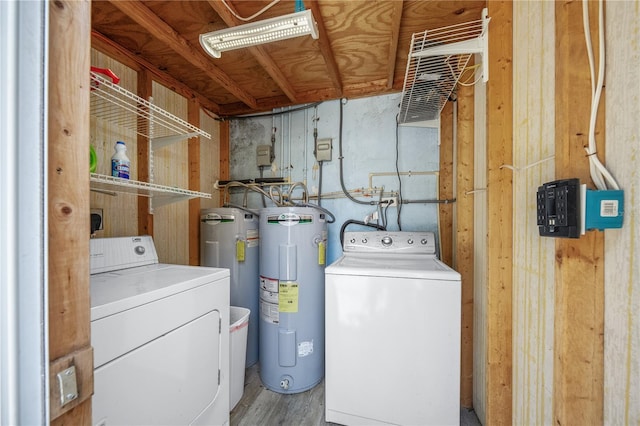 2537 Ashton Rd, Sarasota, FL 34231 - clothes washing area featuring wood finished floors, electric water heater, laundry area, and washing machine and dryer