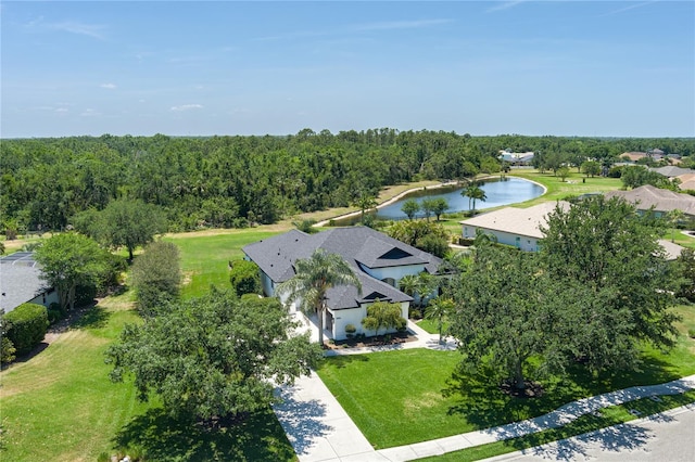 birds eye view of property featuring a forest view and a water view