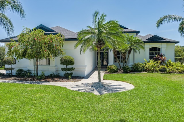 3806 155th Ave E, Parrish, FL 34219 - view of front of property with french doors, a front yard, and stucco siding