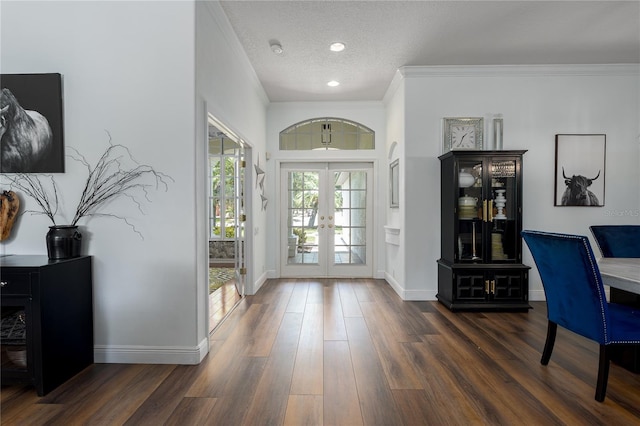 3806 155th Ave E, Parrish, FL 34219 - entrance foyer with french doors, dark wood finished floors, ornamental molding, recessed lighting, and a textured ceiling