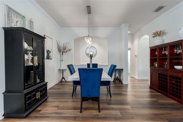 3806 155th Ave E, Parrish, FL 34219 - dining area with arched walkways, ornamental molding, and dark wood finished floors