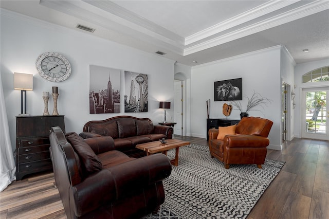 3806 155th Ave E, Parrish, FL 34219 - living area featuring wood finished floors, crown molding, and a raised ceiling