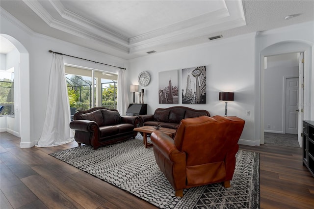 3806 155th Ave E, Parrish, FL 34219 - living area featuring arched walkways, a raised ceiling, crown molding, and hardwood / wood-style flooring