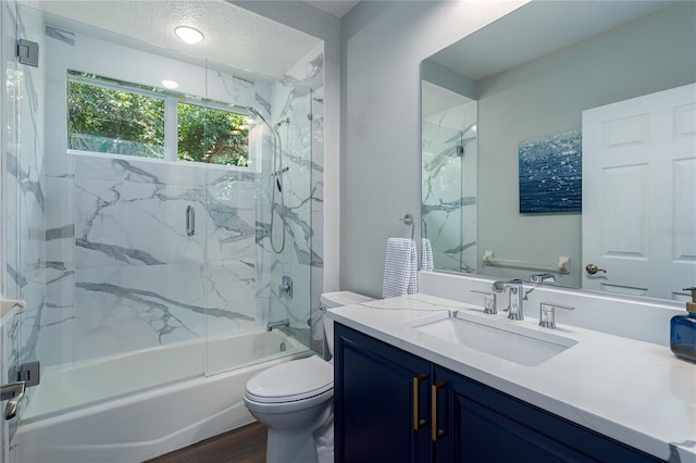 3806 155th Ave E, Parrish, FL 34219 - full bath featuring vanity, bath / shower combo with glass door, and wood finished floors